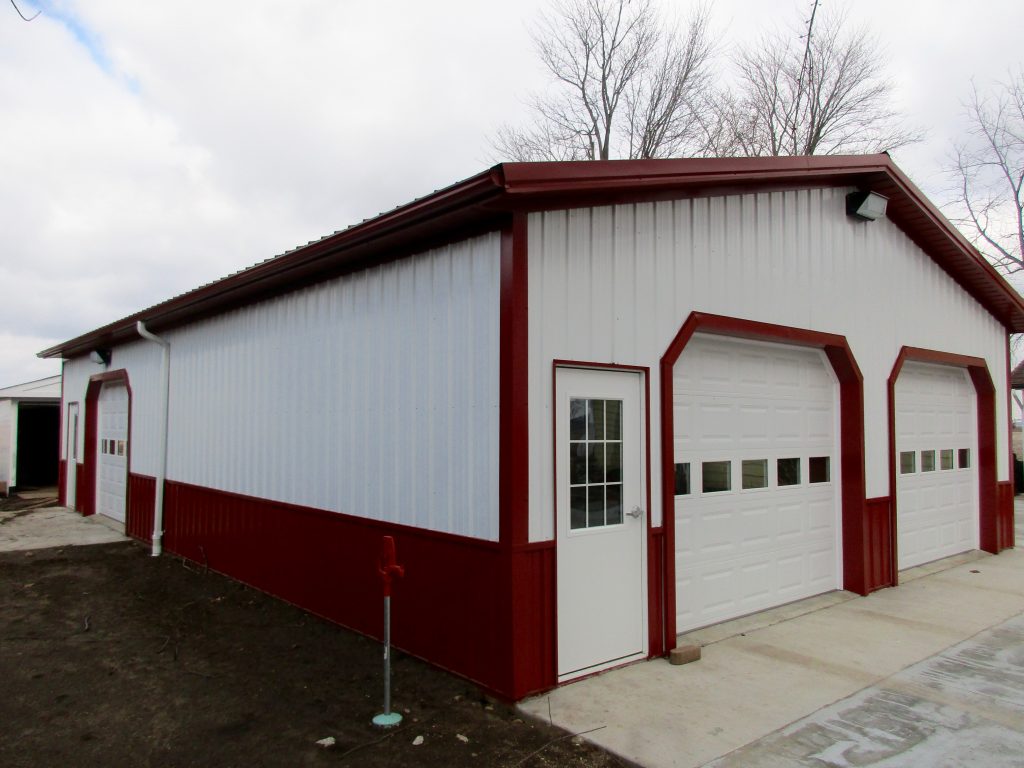 Alan - Leesburg, IN 30 x 48 x 10 Garage with an 8 x 32 x 8 porch. Rustic Red roof, wainscoting, and trim with White sides.