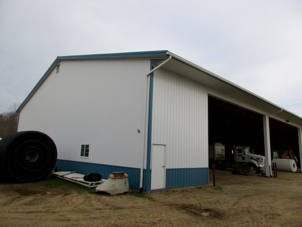 Dale - Galien, MI 80 x 136 x 20 Farm Equipment storage building. White with Blue wainscot.