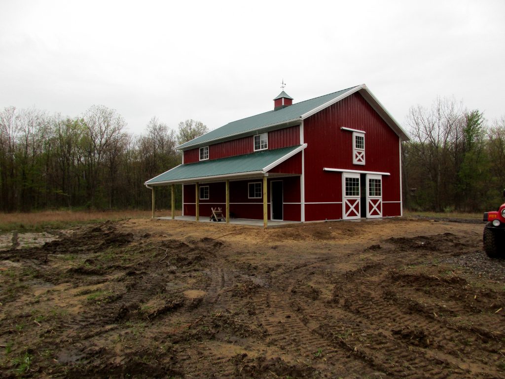 David Roberson Buffalo, MI 30 x 40 x 17 with an 8 x 40 porch with Forest Green roof, Rustic Red sides and White trim.