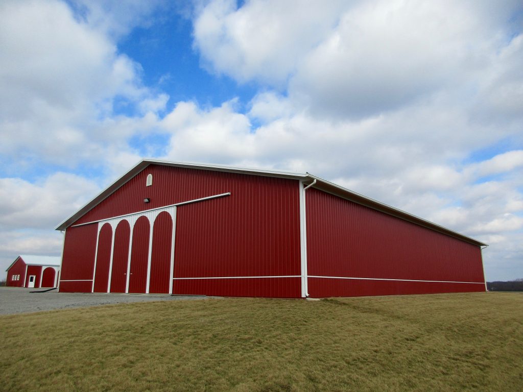 Herbert - Milford, IN 80 x 120 x 17 Farm Building with Arch Design on sliding doors. White roof with Rustic Red sides.