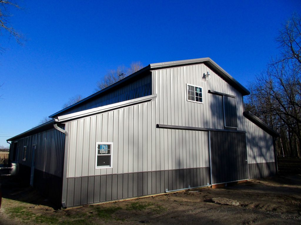 Kathy-Rolling Prairie, IN 24x60x17 with two 12x60x9 lean toos. Charcoal roof, and Grey sides.
